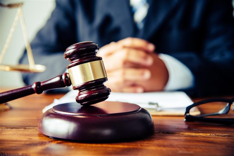 lawyer gavel and crossing fingers