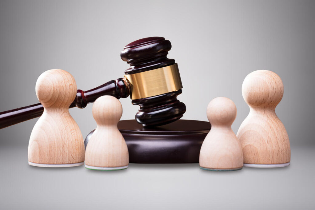 gavel on the table and small statue on the table resembling family members