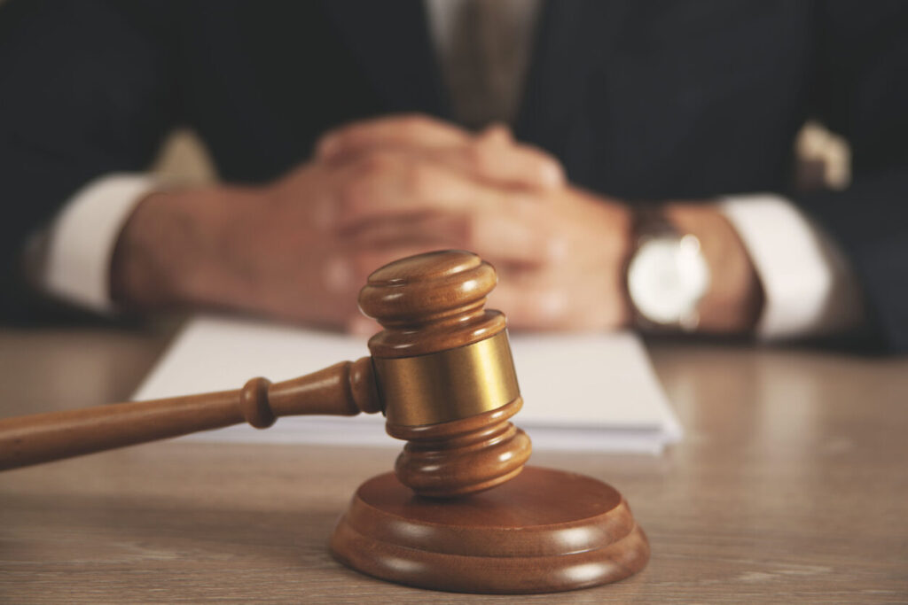 lawyer gavel on the table and lawyer sitting