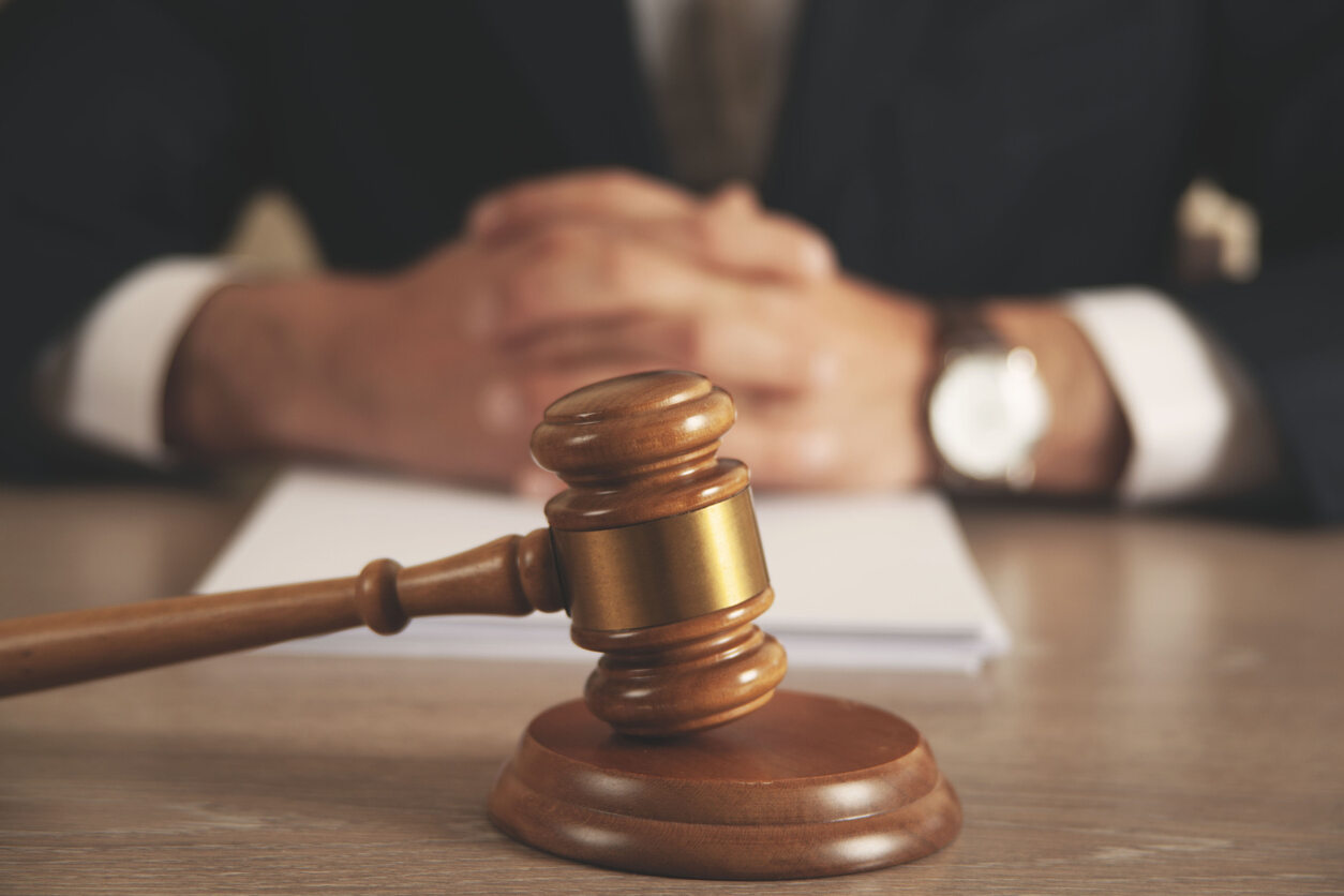 lawyer gavel on the table and lawyer sitting