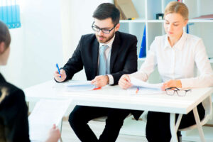 Divorce consultation process: Attorney and client discussing legal paperwork in a modern office setting