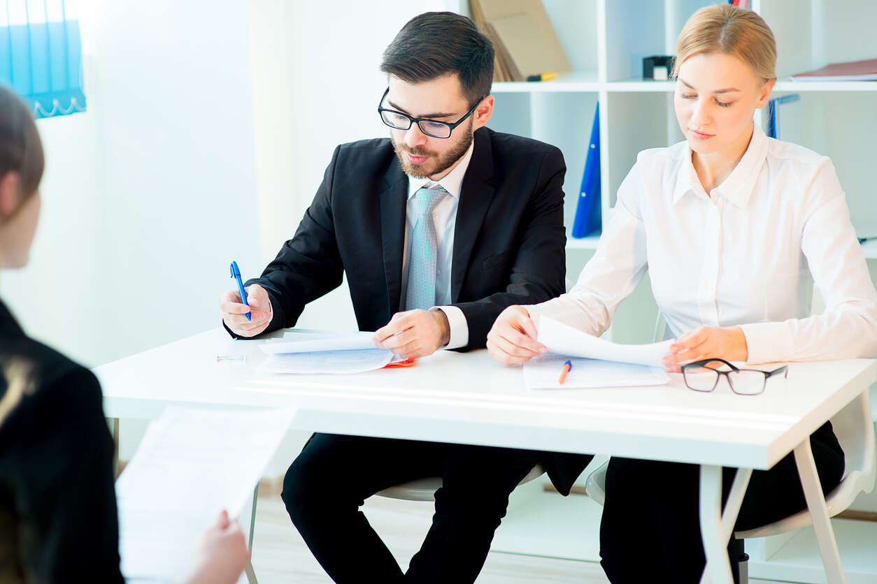 a male and a female signing on divorce paper