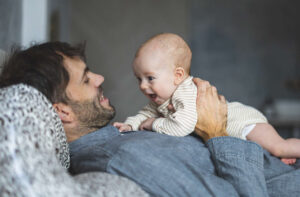 Happy father bonding with infant child, illustrating paternity and father-child relationship