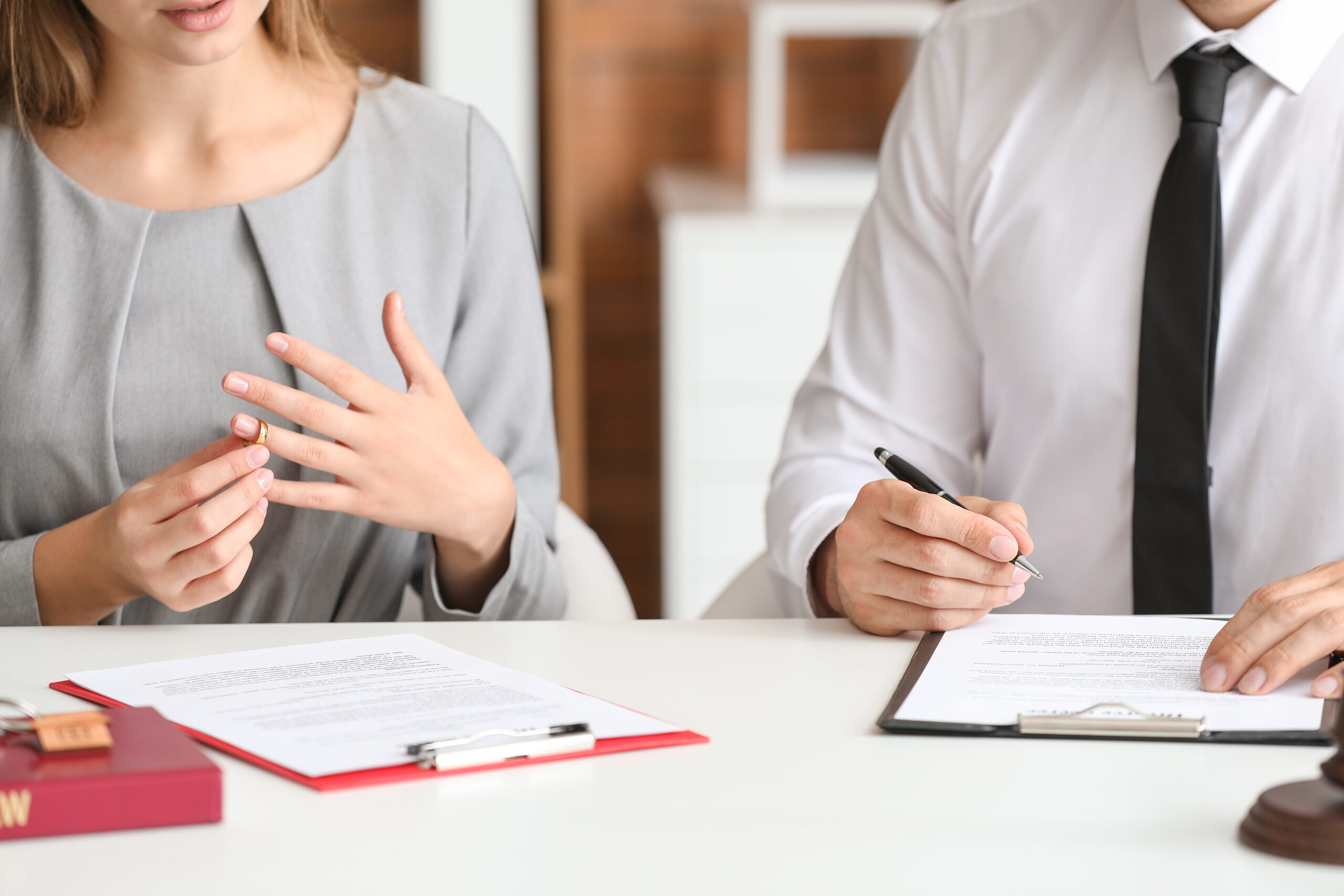 Couple reviewing divorce paperwork with an uncontested divorce attorney in Kansas.