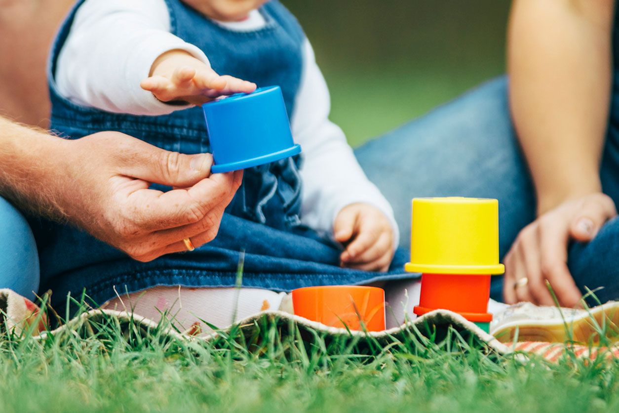 Parents playing with their child in a park concept image, representing Missouri child custody decisions based on the best interests of the child